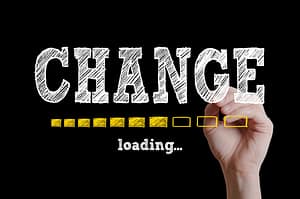 A hand writing the word change with a loading bar beneath - changes to insurance